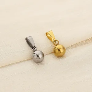 Macro detail of minimalist gold and silver mirror ball pendants made of titanium steel