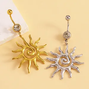 Macro detail of sun vortex stainless steel belly button rings in gold and silver finish