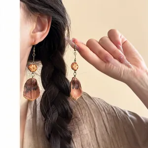 Detailed view of ethnic Maillard style fringe earrings with fruit-like beads