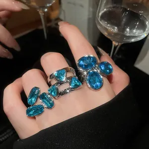 Detailed macro shot of vintage rings with blue gemstones and silver-tone finish.