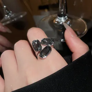 Close-up detail of a retro luxury silver open ring featuring three sparkling oval grey rhinestones