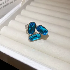 Close-up detail of silver vintage open ring featuring three sparkling blue oval crystals