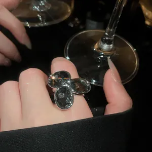 Close-up detail of a luxury vintage open ring featuring three oval dark grey crystals