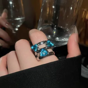 Close-up of a vintage silver ring featuring three triangular blue gemstones.
