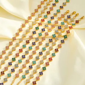 Primo piano di collane con fiori di strass multicolori su sfondo di seta crema