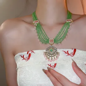 Detailansicht einer mehrlagigen grünen Perlenkette im Vintage-Palaststil am Modell