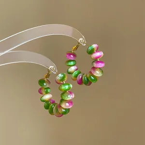 Detailed macro view showing the pink and green gradient resin beaded hoop earrings design