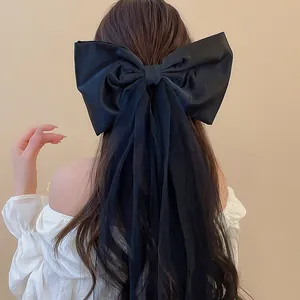 Vue arrière détaillée d'une élégante grande pince à cheveux nœud noir avec tulle