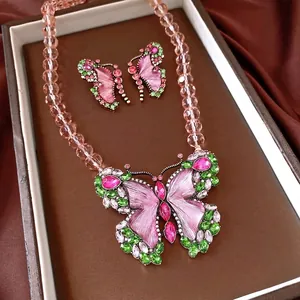 Elegant vintage butterfly jewelry set featuring pink and green crystals and beaded necklace