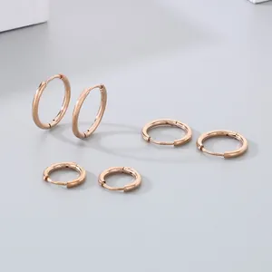 Set of three rose gold stainless steel hoop earrings in various sizes with hinge closure
