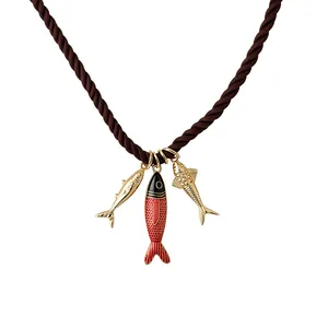 Resort style necklace featuring three decorative metal fish charms on a brown twisted rope cord