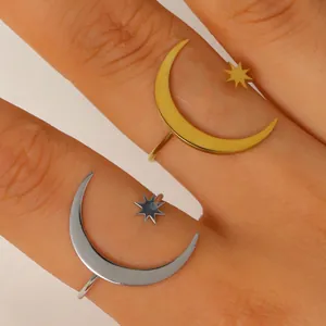 Close-up of trendy gold and silver stainless steel star and moon open rings on fingers