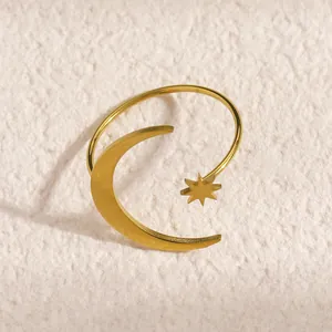 Detailed macro view of gold stainless steel open ring with celestial moon and star motifs