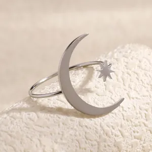 Close-up detail of stainless steel silver celestial star and moon open adjustable ring