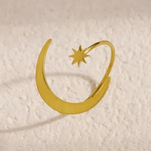 Close-up of minimalist stainless steel gold open ring with star and moon motif design