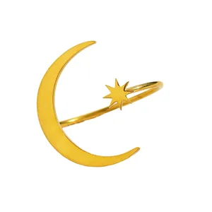 Close-up detail of a minimalist gold stainless steel ring featuring a crescent moon and star