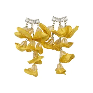 Yellow chiffon flower earrings with sparkling rectangular zircons on white background