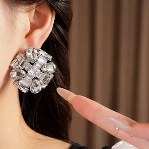 Exaggerated silver needle stud earrings with clear sparkling zircon crystals for elegant women