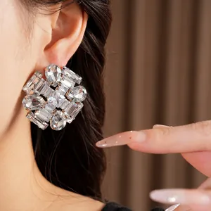 Exquisite close-up of statement silver needle earrings featuring faceted clear zircon