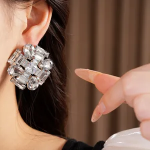 Detailed view of oversized crystal stud earrings with shiny zircon stones