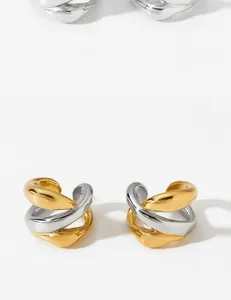 Detail of minimalist irregular line ear clips in gold and silver stainless steel.