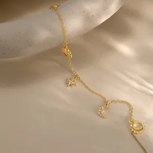 Detailed view of 18k gold plated stainless steel anklet with star and moon charms.