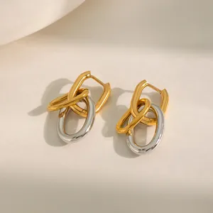 Macro view of bi-color gold and silver interlocking U-shaped stainless steel earrings