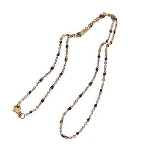 Elegant gold-plated link chain necklace featuring minimalist small black bead accents
