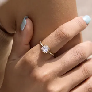 Elegant gold-plated halo ring with a sparkling cushion cut zircon shown on finger detail