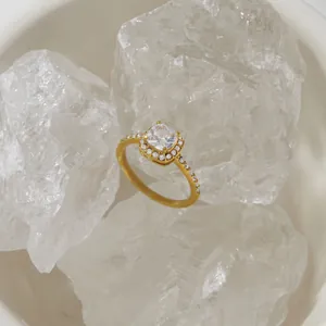Macro view of a gold-plated titanium steel halo ring featuring a square cushion zircon