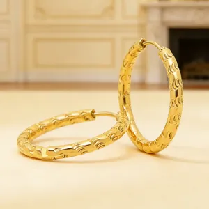 Detailed view of 18K gold plated stainless steel hoop earrings with textured pattern
