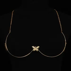 Detailed close-up of a vintage gold-toned hollow butterfly breast chain accessory for Y2K