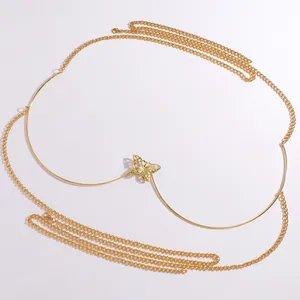 Detailed macro view of a vintage hollow butterfly body chain with a shiny golden finish