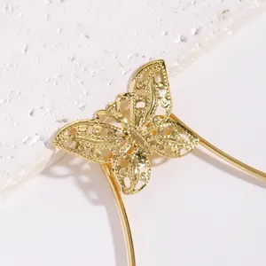 Detailed macro view of vintage golden hollow-out butterfly body chain bikini jewelry