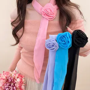 Detail of elegant chiffon flower scarf necklaces in various colors shown on a model.