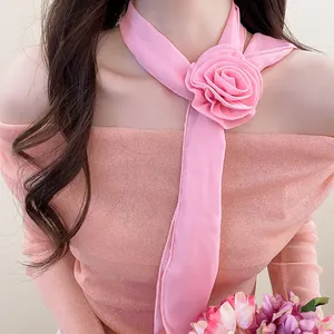 Detailed close-up showing the soft pink chiffon flower and elegant fabric texture of the necklace