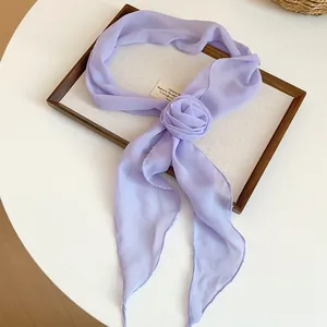 Detail view of light purple chiffon scarf with 3D flower, elegant accessory for women.