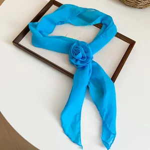 Detailed view of elegant bright blue chiffon flower scarf necklace with rose ornament