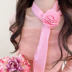 Elegant pink chiffon flower scarf necklace worn by a model in a sweet Korean style detail