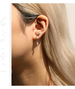 Detailed close-up showing a S925 sterling silver marquise moissanite dangle earring on a model ear