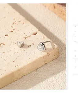 Detail view of S925 sterling silver moissanite triangle stud with heart screw back