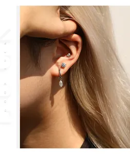 Detailed view of minimalist S925 sterling silver Moissanite screw-back studs on ear