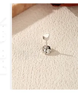 Close-up of S925 sterling silver heart stud earring with shiny moissanite detail