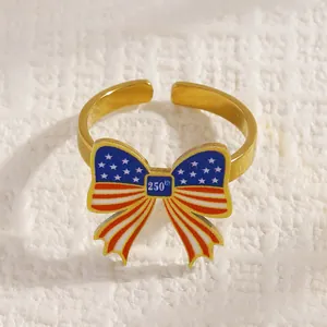 Close-up of a gold bow ring with US flag pattern and 250th anniversary text engraving