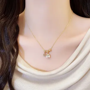 Elegant 18k gold plated necklace with square zircon and floral pendant charms worn on model
