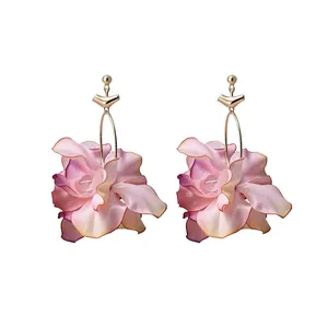 Elegant fabric flower earrings with crystal center and gold hooks on white background