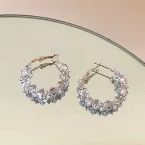 Close-up view of shimmering zircon hoop earrings featuring light purple crystal beads