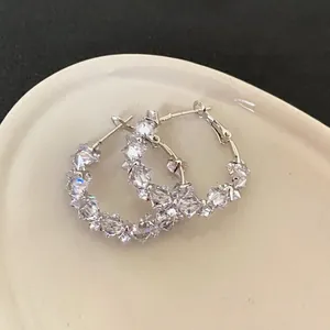 Close-up view of elegant silver hoop earrings with shimmering multifaceted cubic zirconia