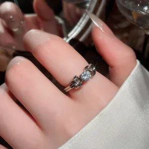 Elegante anello con fiocco color argento e gemma scintillante al dito.