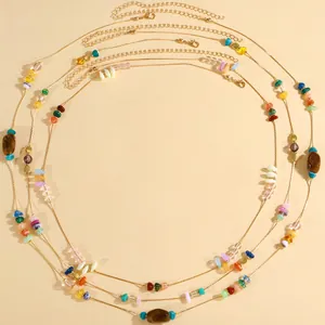 Detail of vintage ethnic style waist chain with irregular colorful crushed stones for beach